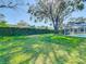 Spacious backyard with a lush lawn and an inviting pool at 2725 Onizuka Ct, Palm Harbor, FL 34683