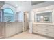 Bathroom featuring a large garden tub and shower behind a glass enclosure at 2725 Onizuka Ct, Palm Harbor, FL 34683