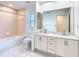 Neutral primary bath with large mirror, double sinks, a bathtub and vanity space at 2725 Onizuka Ct, Palm Harbor, FL 34683