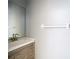 Bathroom featuring grey vanity with white countertop, rectangular mirror, and towel bar at 2725 Onizuka Ct, Palm Harbor, FL 34683