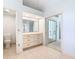 Light-filled bathroom with tiled floors, built-in vanity with drawers, and a toilet at 2725 Onizuka Ct, Palm Harbor, FL 34683