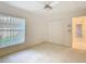 Bedroom with carpet flooring, large window, and closet space at 2725 Onizuka Ct, Palm Harbor, FL 34683
