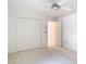 This bright bedroom features a ceiling fan, a double door closet and a hallway entrance at 2725 Onizuka Ct, Palm Harbor, FL 34683