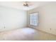 This bright bedroom has a ceiling fan and a large window overlooking the property at 2725 Onizuka Ct, Palm Harbor, FL 34683