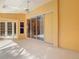 View of the covered patio featuring ceiling fan, sliding glass doors, and access to the pool area at 2725 Onizuka Ct, Palm Harbor, FL 34683