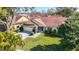 Exterior aerial view showcasing landscaping, well-kept lawn, and two-car garage at 2725 Onizuka Ct, Palm Harbor, FL 34683