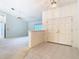 Bright foyer featuring double doors, neutral tile flooring, and a glimpse into the living area at 2725 Onizuka Ct, Palm Harbor, FL 34683