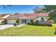 Charming single-story home with well-manicured lawn, brick accents, and a two-car garage at 2725 Onizuka Ct, Palm Harbor, FL 34683