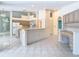 Open-concept kitchen with tile flooring, an island, stainless steel appliances, and ample counter space at 2725 Onizuka Ct, Palm Harbor, FL 34683