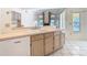 Bright kitchen area featuring a sink, wood cabinets, and an open layout leading to living spaces and a patio at 2725 Onizuka Ct, Palm Harbor, FL 34683