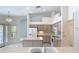Bright kitchen featuring an island, white appliances, and easy access to the dining area at 2725 Onizuka Ct, Palm Harbor, FL 34683