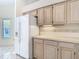 Kitchen area showcasing a refrigerator and wood cabinets with ample storage and a bright, clean design at 2725 Onizuka Ct, Palm Harbor, FL 34683