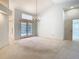 Spacious living room features vaulted ceilings and french doors leading to outdoor spaces at 2725 Onizuka Ct, Palm Harbor, FL 34683