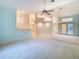 Spacious living room offering carpet flooring, multiple ceiling fans and light fixtures, and a neutral color palette at 2725 Onizuka Ct, Palm Harbor, FL 34683