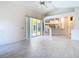 Bright living room features vaulted ceiling, ceiling fan, and sliding glass doors to lanai at 2725 Onizuka Ct, Palm Harbor, FL 34683