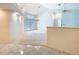 Bright living room with a high ceiling, tile flooring, a chandelier, and glass doors to the backyard at 2725 Onizuka Ct, Palm Harbor, FL 34683