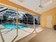 Inviting screened-in pool area with plenty of space for outdoor lounging at 2725 Onizuka Ct, Palm Harbor, FL 34683
