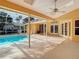 Enjoy this covered outdoor space with a pool and outdoor recreation at 2725 Onizuka Ct, Palm Harbor, FL 34683