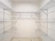 Large walk-in closet featuring wire shelving on all sides for ample storage capacity at 2725 Onizuka Ct, Palm Harbor, FL 34683