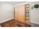 Flex room with a wall bed and shelves featuring gray wood floors and modern styling at 2757 Countryside Blvd # 103, Clearwater, FL 33761