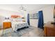 Bright bedroom featuring neutral walls, blue accents, a ceiling fan, and comfortable furnishings at 2757 Countryside Blvd # 103, Clearwater, FL 33761