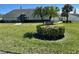 Charming clubhouse entrance with lush landscaping and mature palm trees on a sunny day at 2757 Countryside Blvd # 103, Clearwater, FL 33761