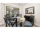 Cozy dining area featuring a glass table, elegant chairs, stylish buffet, and sliding glass doors to the outdoors at 2757 Countryside Blvd # 103, Clearwater, FL 33761