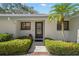 Charming villa front entrance, with lush landscaping, accentuating a welcoming appeal and curb appeal at 2757 Countryside Blvd # 103, Clearwater, FL 33761