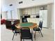 Clubhouse game room with kitchen, refrigerator, seating, and game table at 2757 Countryside Blvd # 103, Clearwater, FL 33761