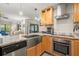 Open kitchen with stainless steel appliances, marble countertops, sink, and wooden cabinets at 2757 Countryside Blvd # 103, Clearwater, FL 33761