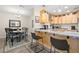 Kitchen featuring updated appliances, breakfast bar seating, and an adjacent dining area, creating a cozy space at 2757 Countryside Blvd # 103, Clearwater, FL 33761