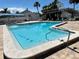 Community pool with clean, clear water and accessible entry steps at 2757 Countryside Blvd # 103, Clearwater, FL 33761
