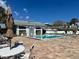 Exterior image of community pool with tables, lounge chairs, and a well-maintained patio area at 2757 Countryside Blvd # 103, Clearwater, FL 33761
