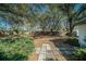 Private backyard with wooden fence, mature trees, and patio area offering a serene retreat at 3013 Ridgevale Cir, Valrico, FL 33596