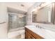 Bathroom showcasing marble countertop, wood cabinets, tub, shower with glass door, and chrome fixtures at 3013 Ridgevale Cir, Valrico, FL 33596