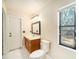 Bathroom features include a single sink vanity, toilet, tiled floors, and large window at 3013 Ridgevale Cir, Valrico, FL 33596