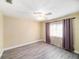 Cozy bedroom featuring wood-look flooring, a ceiling fan, and a window with privacy curtains at 3013 Ridgevale Cir, Valrico, FL 33596
