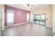 Spacious bedroom featuring a pastel accent wall, wood-look flooring, and a sliding glass door leading to lanai at 3013 Ridgevale Cir, Valrico, FL 33596