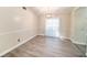 Dining room features gray wood flooring, neutral paint, and a modern light fixture at 3013 Ridgevale Cir, Valrico, FL 33596