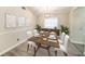 Formal dining room features wood table setting, modern decor and natural light from the window at 3013 Ridgevale Cir, Valrico, FL 33596