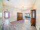 Formal dining room featuring elegant furnishings, modern light fixtures, and seamless wood-look flooring at 3013 Ridgevale Cir, Valrico, FL 33596