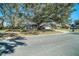 Street view of a single-story home with a well-maintained front yard and mature trees at 3013 Ridgevale Cir, Valrico, FL 33596