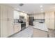 Bright kitchen with stainless steel appliances, granite countertops, white cabinets, and modern backsplash at 3013 Ridgevale Cir, Valrico, FL 33596