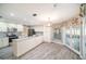 Bright kitchen with stainless steel appliances, granite countertops, tile backsplash, and double doors at 3013 Ridgevale Cir, Valrico, FL 33596