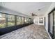 Enclosed lanai featuring tile flooring, ample seating area, and views of the well-maintained backyard at 3013 Ridgevale Cir, Valrico, FL 33596