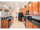 Modern kitchen with stainless steel appliances, granite countertops, and ample cabinet space at 350 Cockle Shell Loop, Apollo Beach, FL 33572