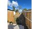 Newly fenced backyard featuring a gate, green space, and a paver patio at 3623 N 53Rd St, Tampa, FL 33619