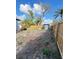 Backyard showcasing partial landscaping, a new shed, and a wooden fence for privacy at 3623 N 53Rd St, Tampa, FL 33619