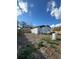 Backyard with privacy fence and the home's rear, offering space for a grill and shed at 3623 N 53Rd St, Tampa, FL 33619
