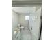 Bright bathroom with a granite vanity, toilet, and tiled shower with a white shower curtain at 3623 N 53Rd St, Tampa, FL 33619